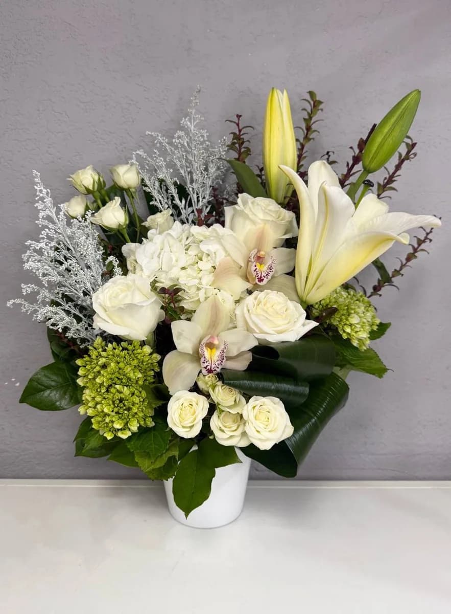 Heaven small sympathy floral arrangement with white roses, orchids, lilies and hydrangeas by Bana Florist Toronto