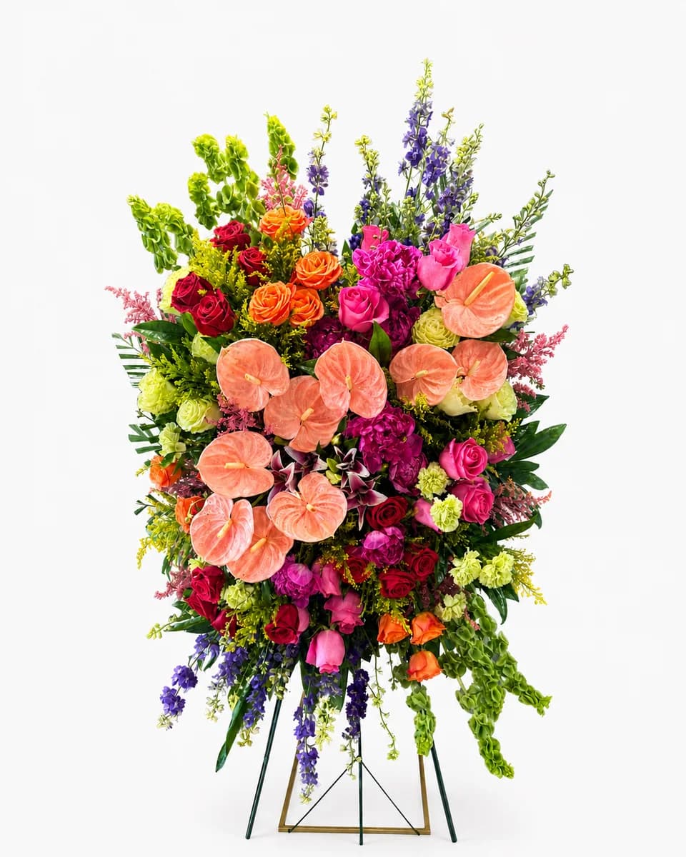 Mixed flower standing spray with peach anthuriums and roses on an easel from Bana Florist Toronto